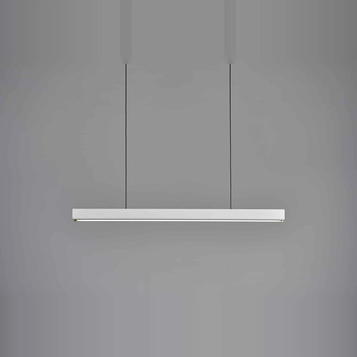 Linear LED pendant with wood ends, in matte white, lit