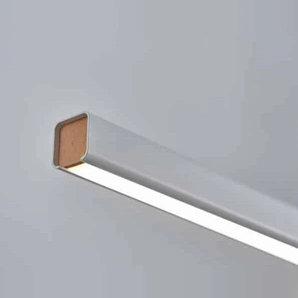 Linear LED pendant with wood ends, close-up of the beech end cap