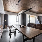 Linear LED pendant with wood ends, above a long dining table