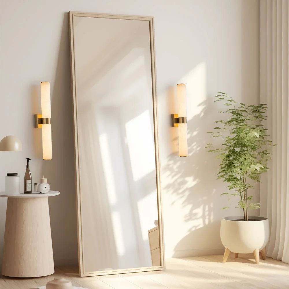 Linear LED wall light with a veined shade, beside a full-length mirror