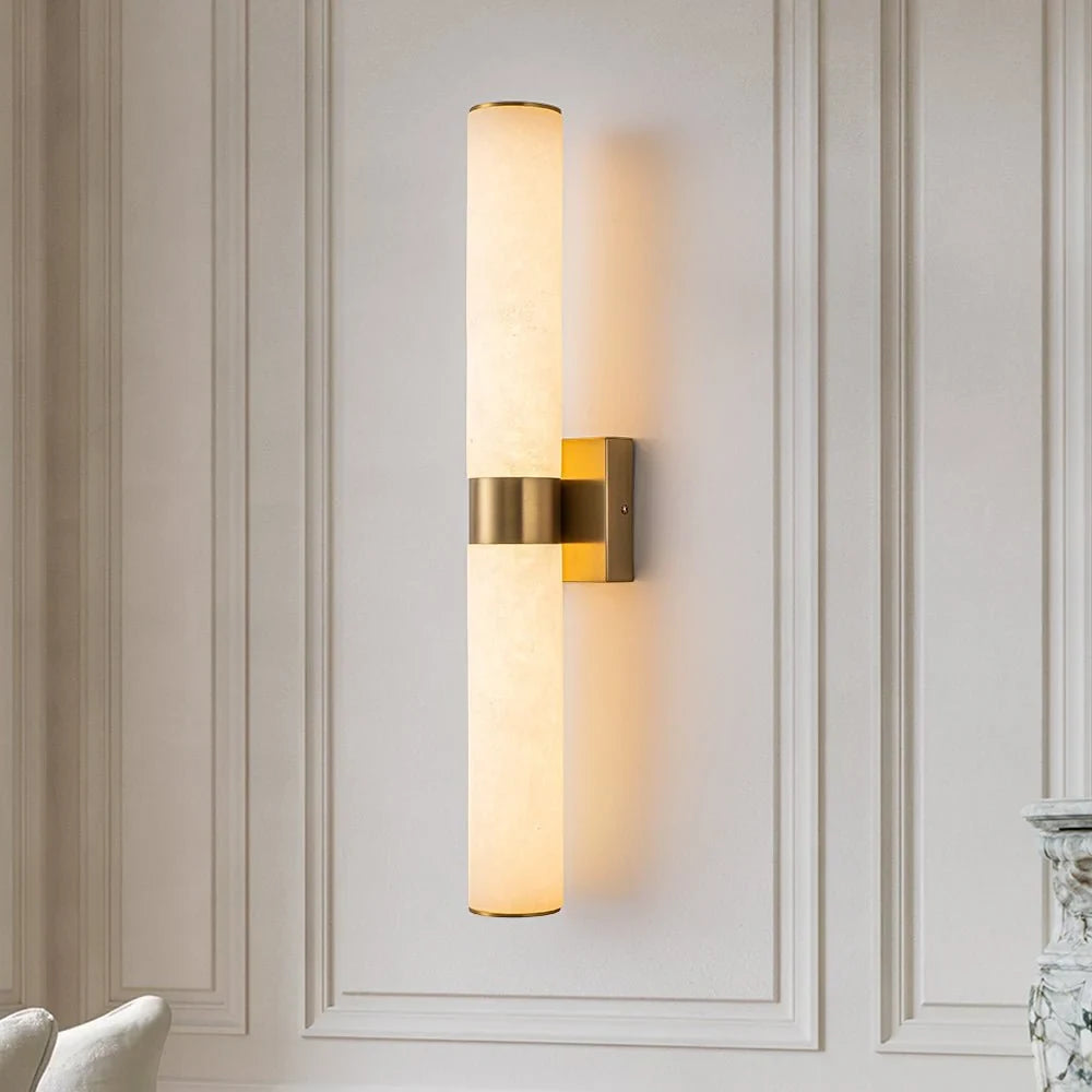 Linear LED wall light with a veined shade, in brass, on a panelled wall