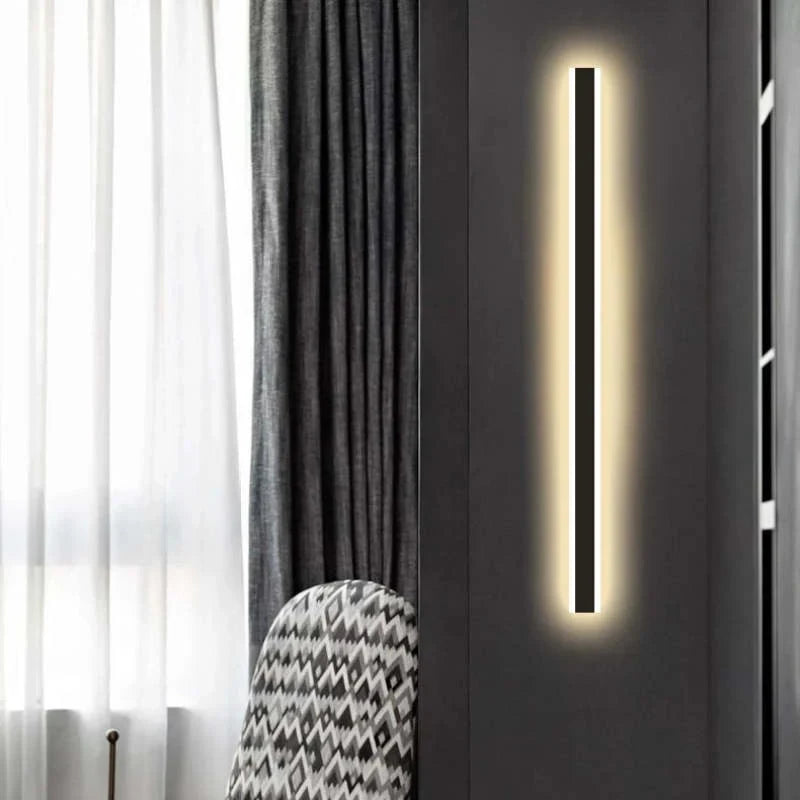 Linear outdoor wall light with a clear edge, lit on an outside wall