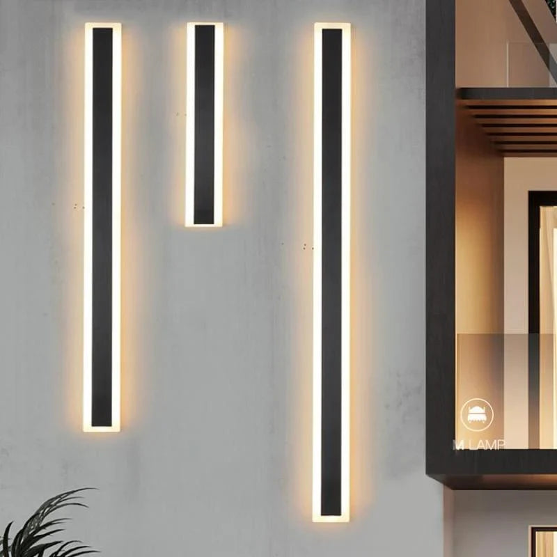 Linear outdoor wall light with a clear edge, lit on an outside wall