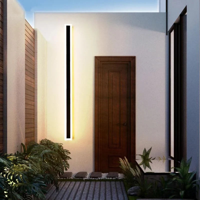 Linear outdoor wall light with a clear edge, lit on an outside wall