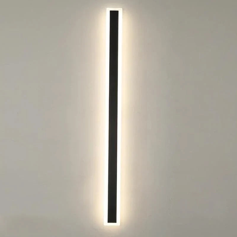 Linear outdoor wall light with a clear edge, lit