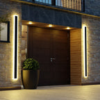 Linear outdoor wall light with a clear edge, lit on an outside wall