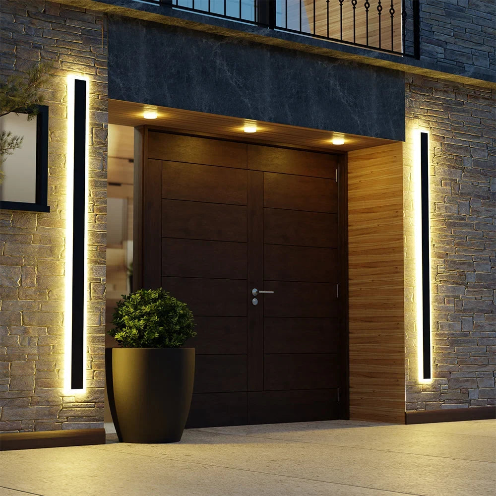 Linear outdoor wall light with a clear edge, lit on an outside wall