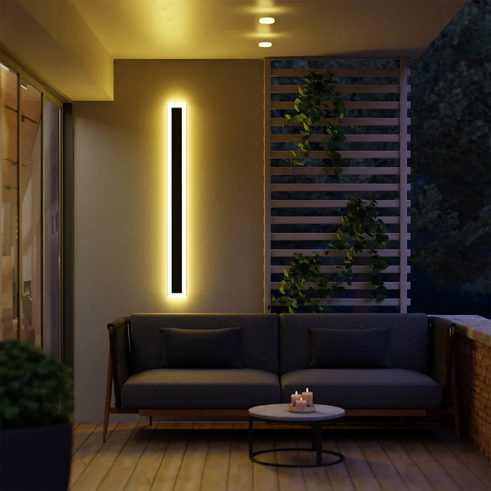 Linear outdoor wall light with a clear edge, lit on an outside wall