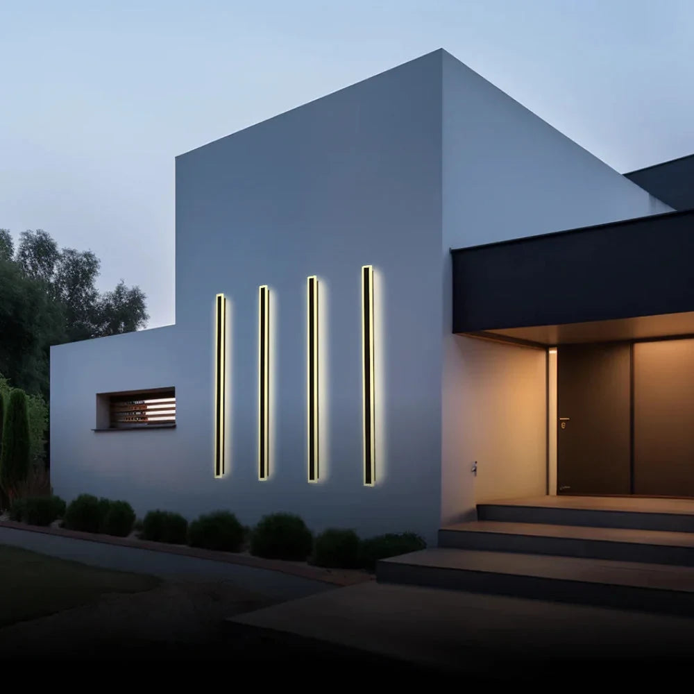 Linear outdoor wall light with a clear edge, lit on an outside wall