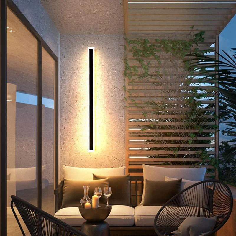 Linear outdoor wall light with a clear edge, lit on an outside wall