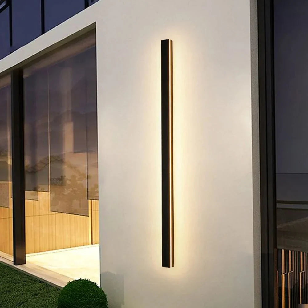 Linear LED outdoor wall light, lit on a wall