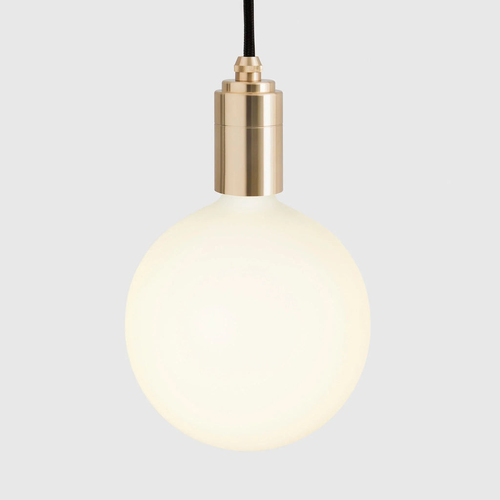 Linear triple opal globe pendant, close-up of a brass holder and globe
