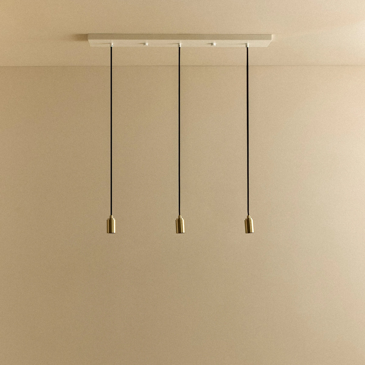 Linear triple pendant, with brass holders and white canopy, no bulbs