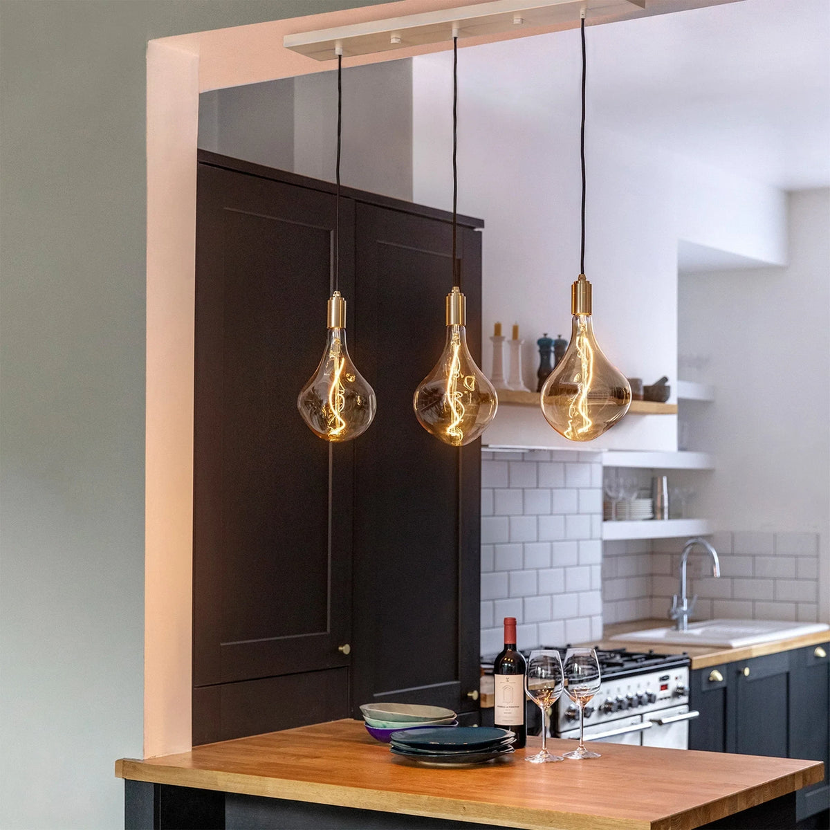 Linear triple pendant, above a wooden worktop