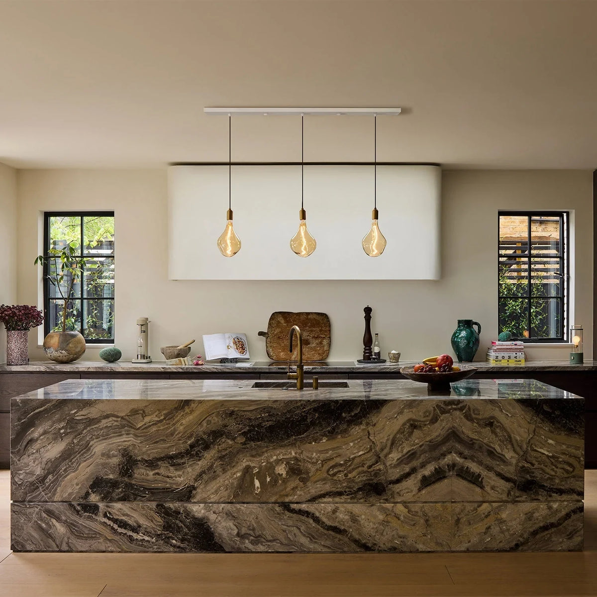 Linear triple pendant, over a marble kitchen island