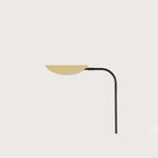 Low-arc reading floor lamp with brass shade, close-up of the brass shade