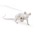Lying down white mouse table lamp, beside a globe bulb