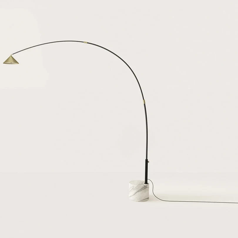 Arc floor lamp with marble base and swivel head, on a white marble base against a plain wall