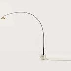 Arc floor lamp with marble base and swivel head, on a white marble base against a plain wall
