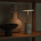 Cordless marble base table lamp, mini, on a shelf, lit