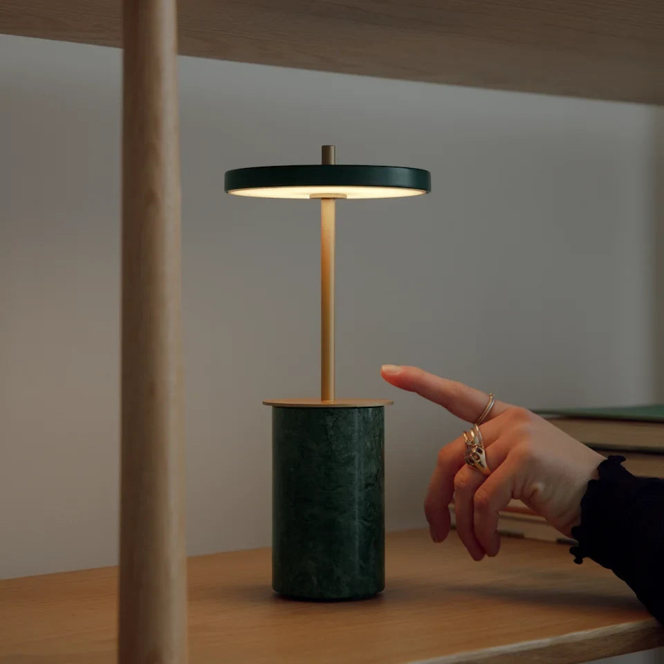 Cordless marble base table lamp, mini, green marble, hand touching the disc