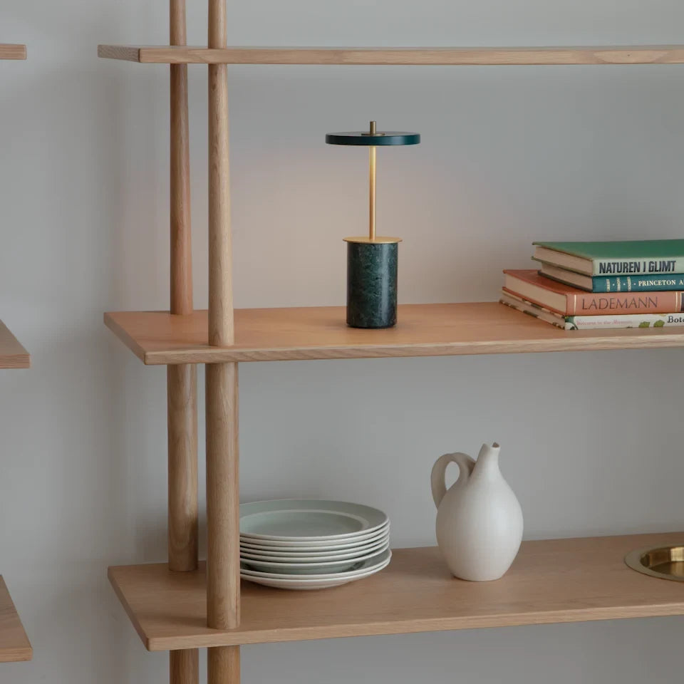 Cordless marble base table lamp, mini, green marble, on a shelf with plates