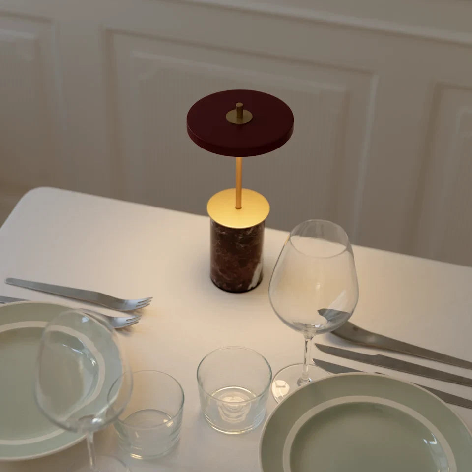 Cordless marble base table lamp, mini, red marble, on a laid table