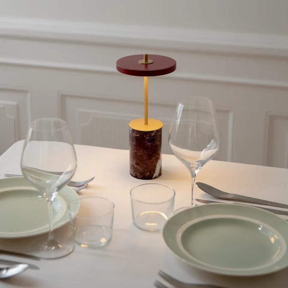 Cordless marble base table lamp, mini, red marble, lit at dinner