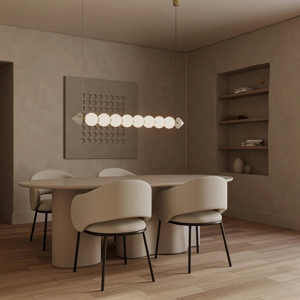 Marble bead linear LED pendant, lit above an oval dining table