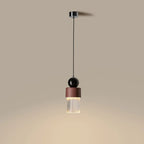 Marble, ceramic and striped glass pendant, lit, casting a warm glow