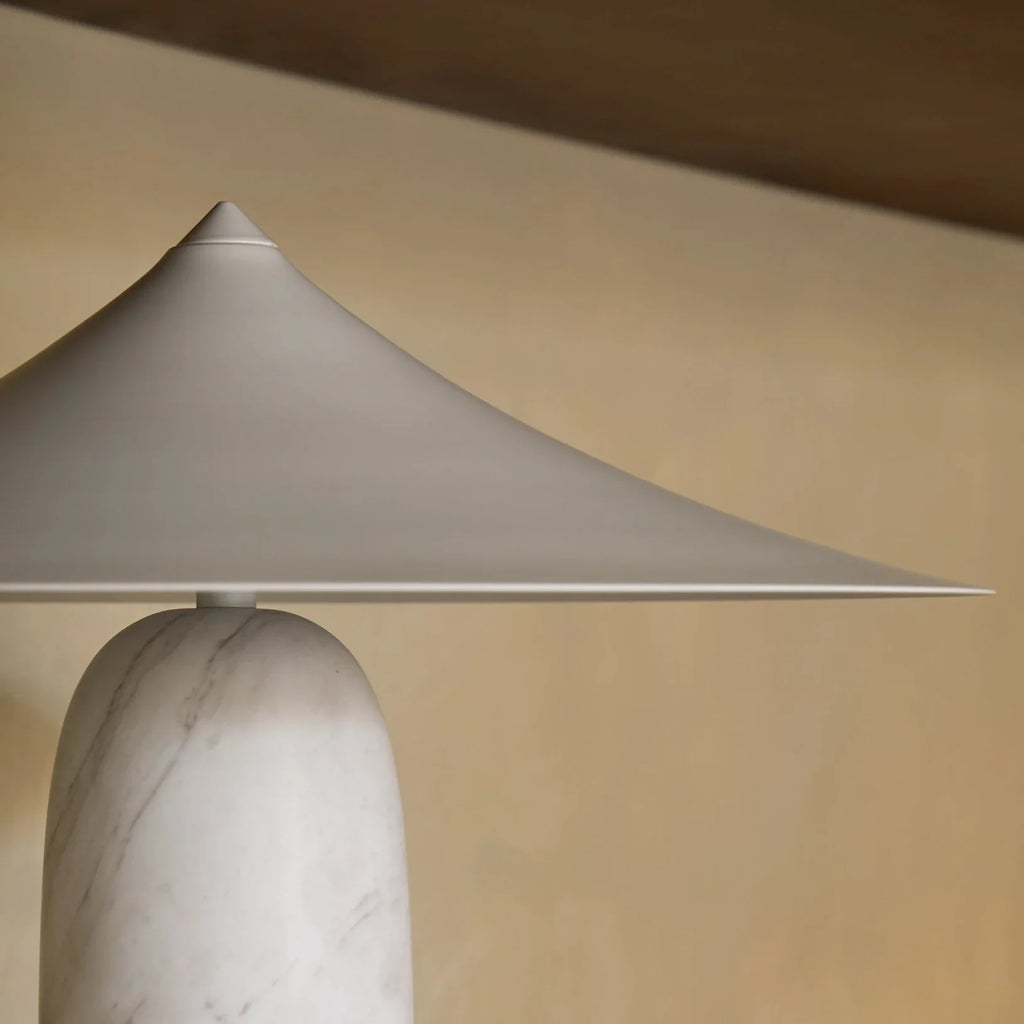 Marble table lamp with a wide pointed shade, close-up of the shade and marble base