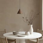 Marble cone LED pendant, above a round dining table