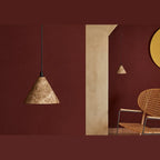 Marble cone LED pendant, against a dark red wall