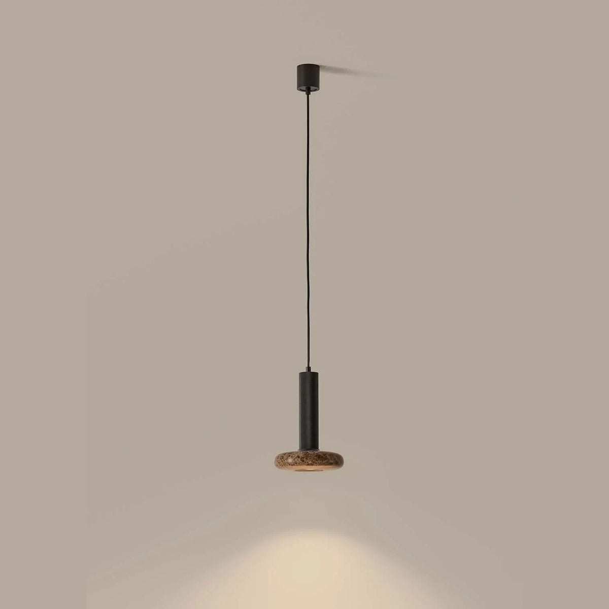 Marble disc cylinder pendant, lit, casting light below