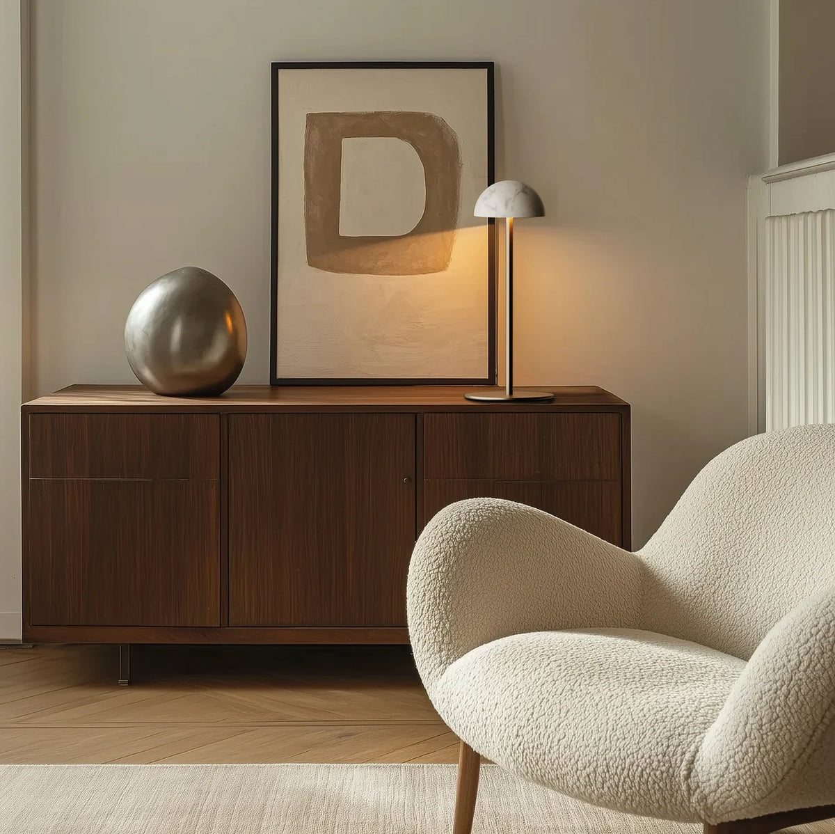 Marble dome table lamp on a slim stem, on a sideboard in a living room
