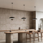 Matt black dome pendant with hanging diffuser disc, three pendants above a kitchen island