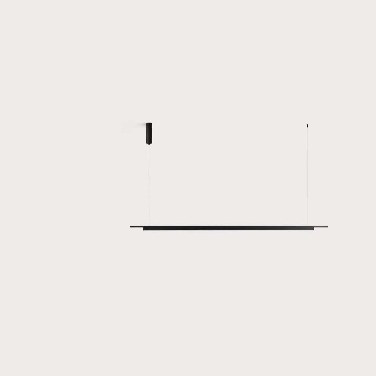 Matte black linear LED bar pendant, on a plain background