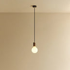 Matte white glass pendant, mouth-blown bulb, walnut, lit, hung from the ceiling