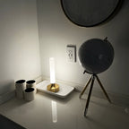 Frosted column cordless table lamp, lit in a room setting