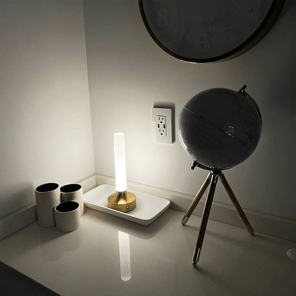 Frosted column cordless table lamp, lit in a room setting