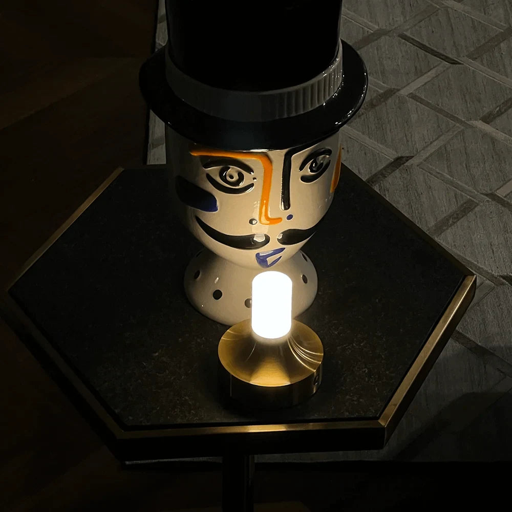 Frosted column cordless table lamp, lit in a room setting