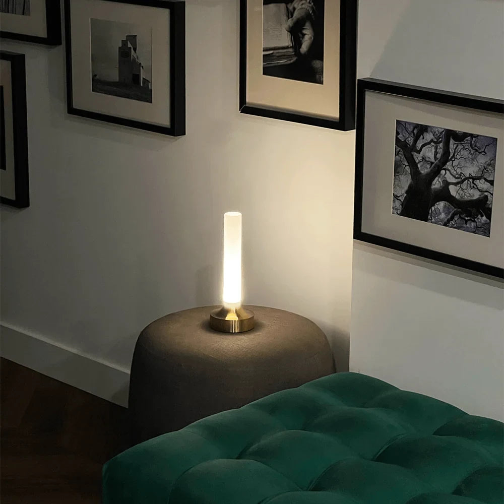 Frosted column cordless table lamp, lit in a room setting
