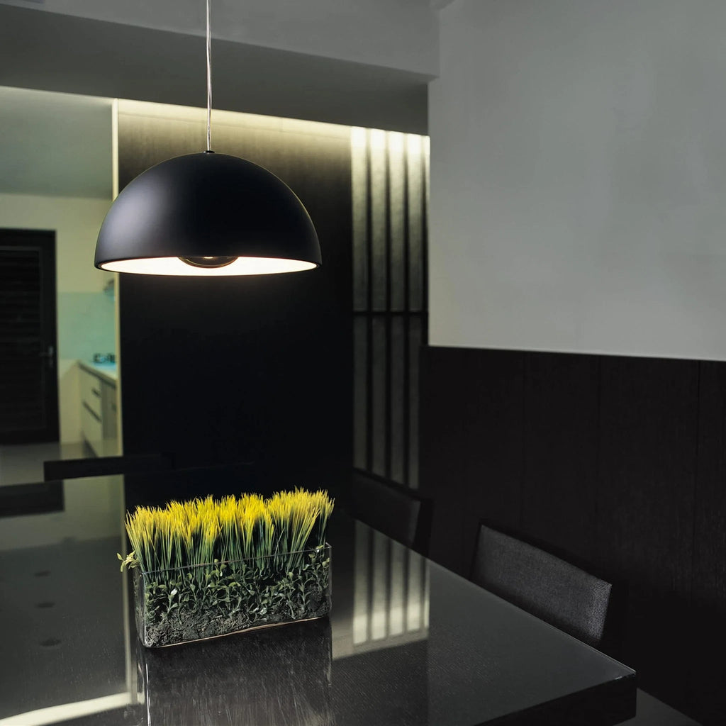 Metal dome pendant, in black above a dining table