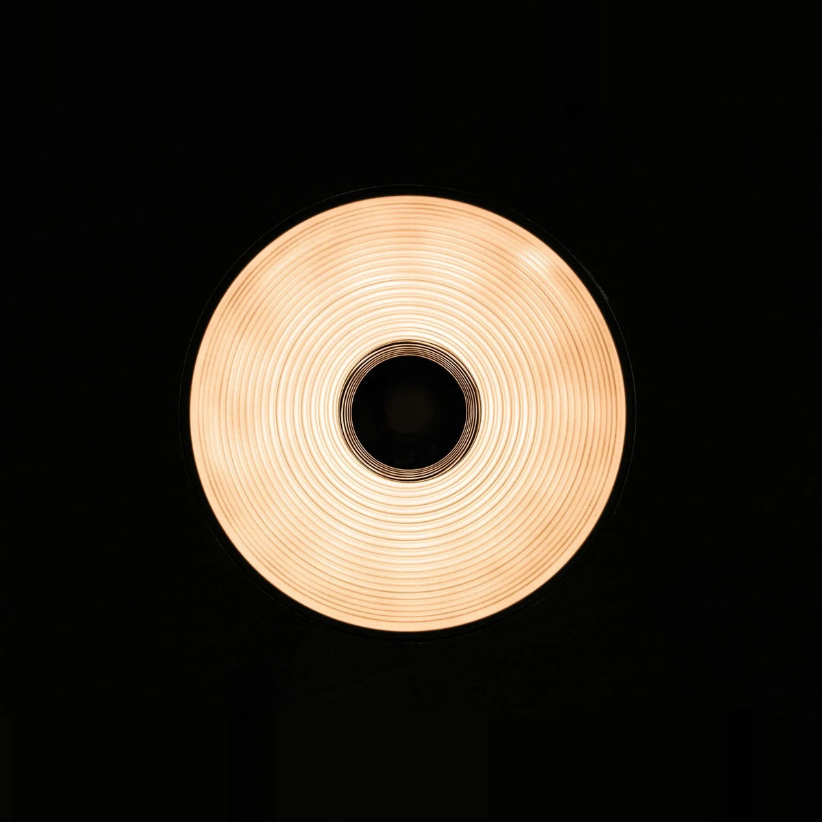 Metal dome pendant, lit, seen from below