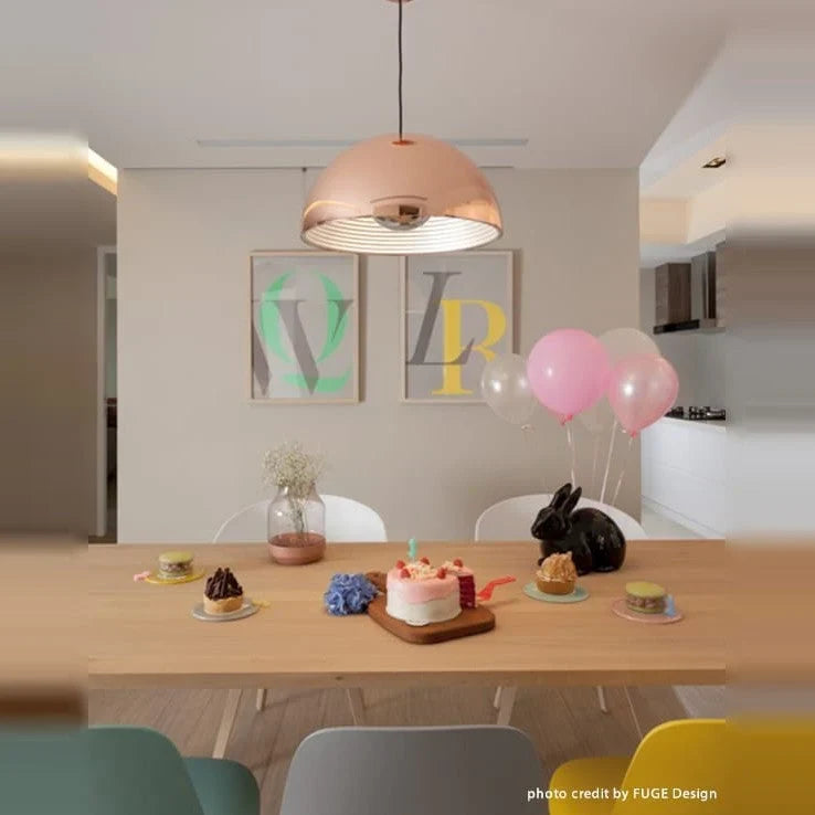 Metal dome pendant, in copper above a dining table
