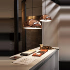 Metal dome pendant, in copper above a kitchen worktop