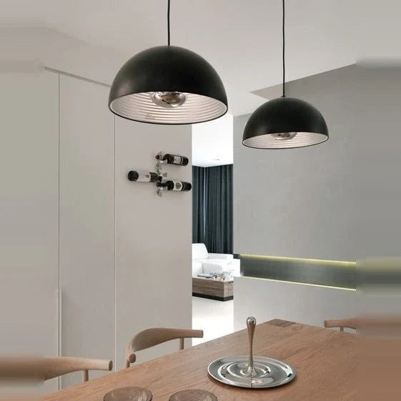 Metal dome pendant, in black above a dining table
