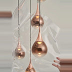 Mirrored Teardrop Five-Light Linear Pendant, close-up of copper shades