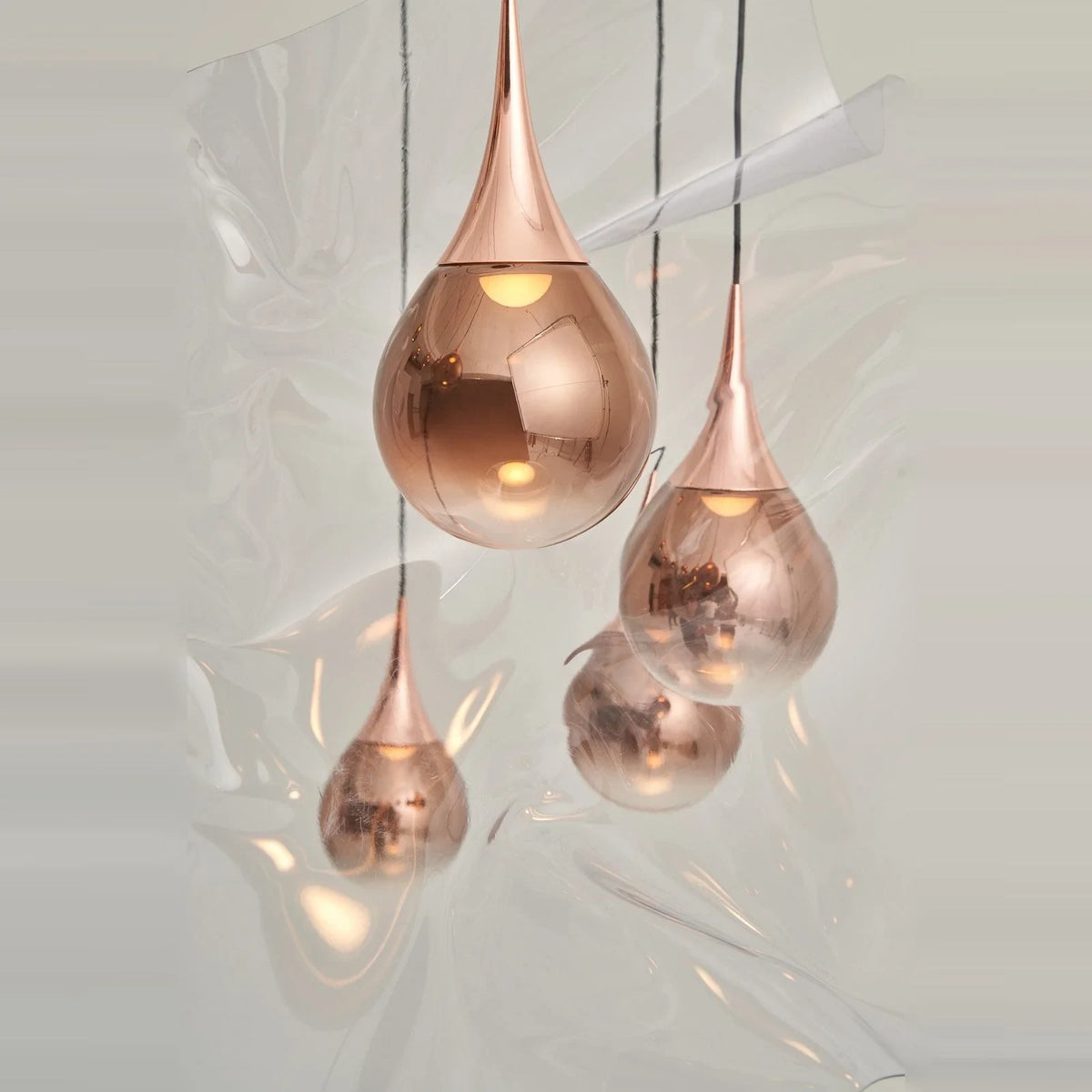 Mirrored Teardrop Five-Light Linear Pendant, close-up of copper shades, lit