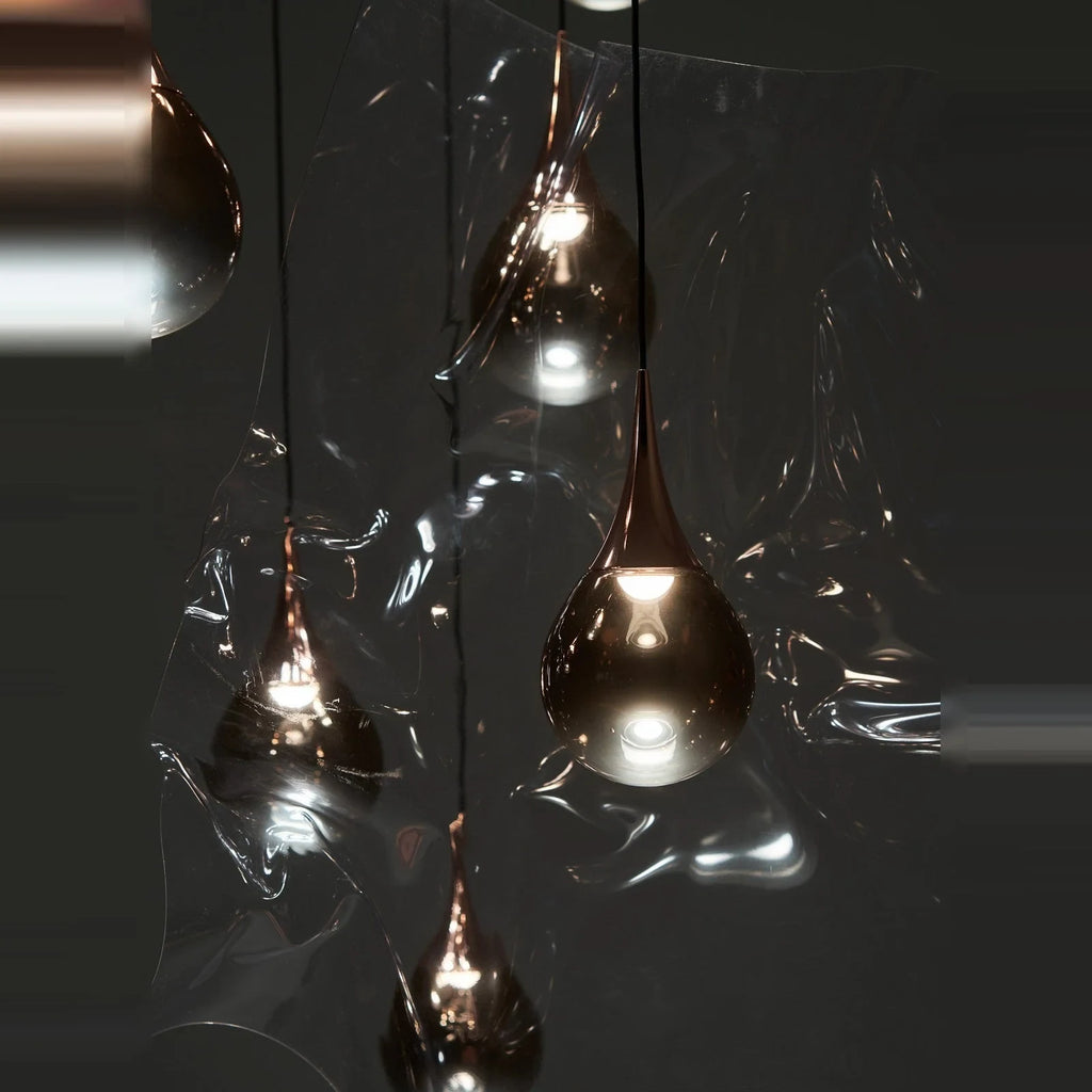 Mirrored Teardrop Five-Light Linear Pendant, close-up of shades in a dark setting